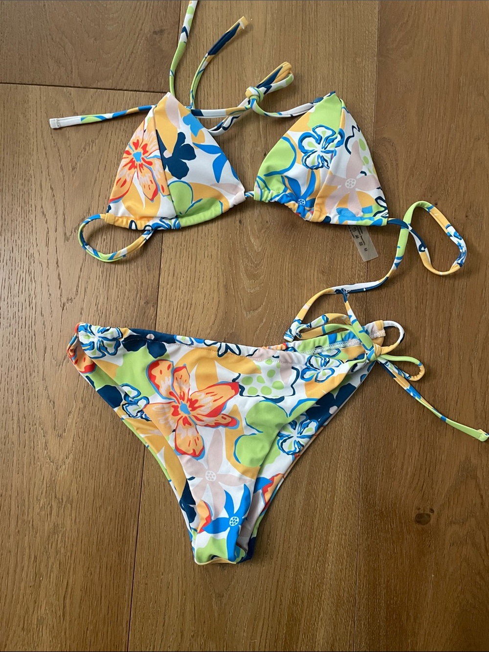 Floral and white bikini. Medium triangle top. Large bottom with tie on side.